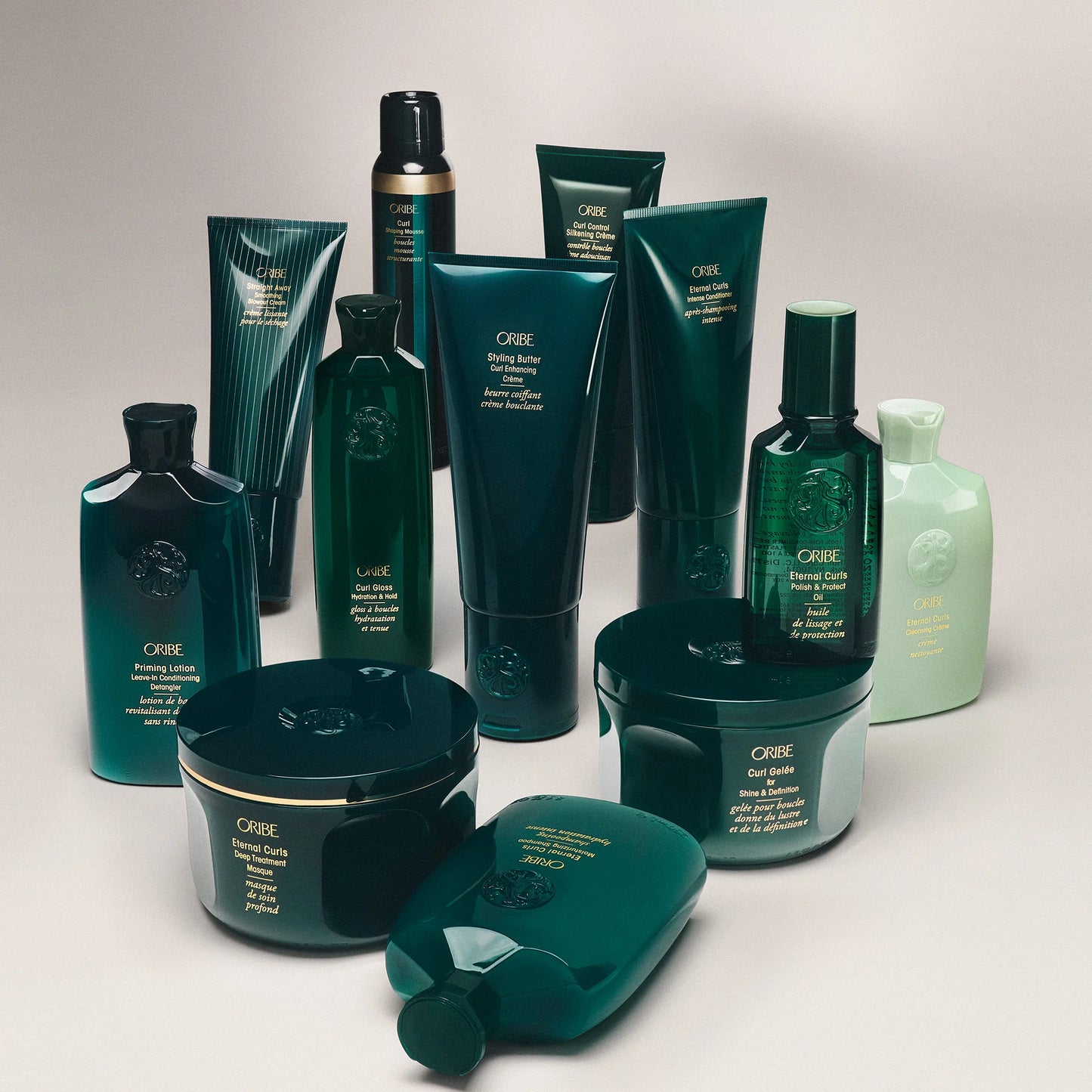 Collection of Oribe Eternal Curls hair care products on a light gray background