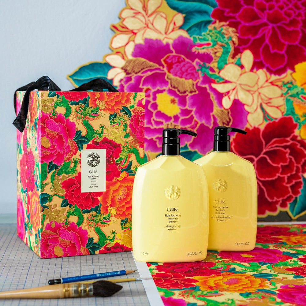 Oribe Hair Alchemy shampoo and conditioner set with vibrant gift box for premium hair care gifting