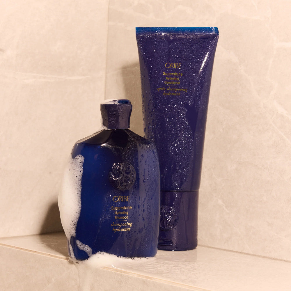 Oribe Supershine shampoo and conditioner in deep blue packaging for moisturizing and smoothing hair