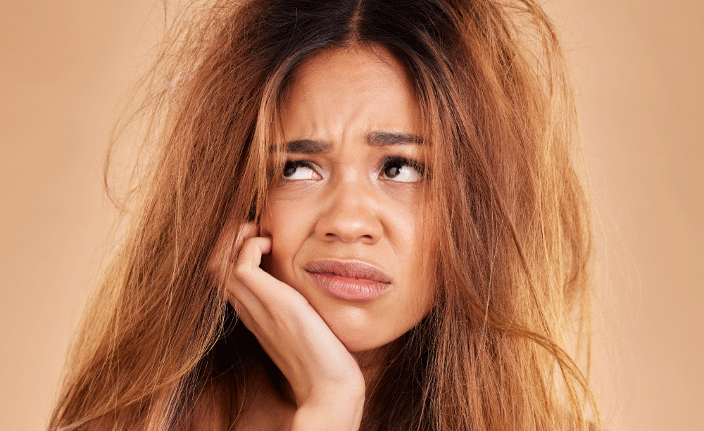 women frustrasted with frizzy dry hair