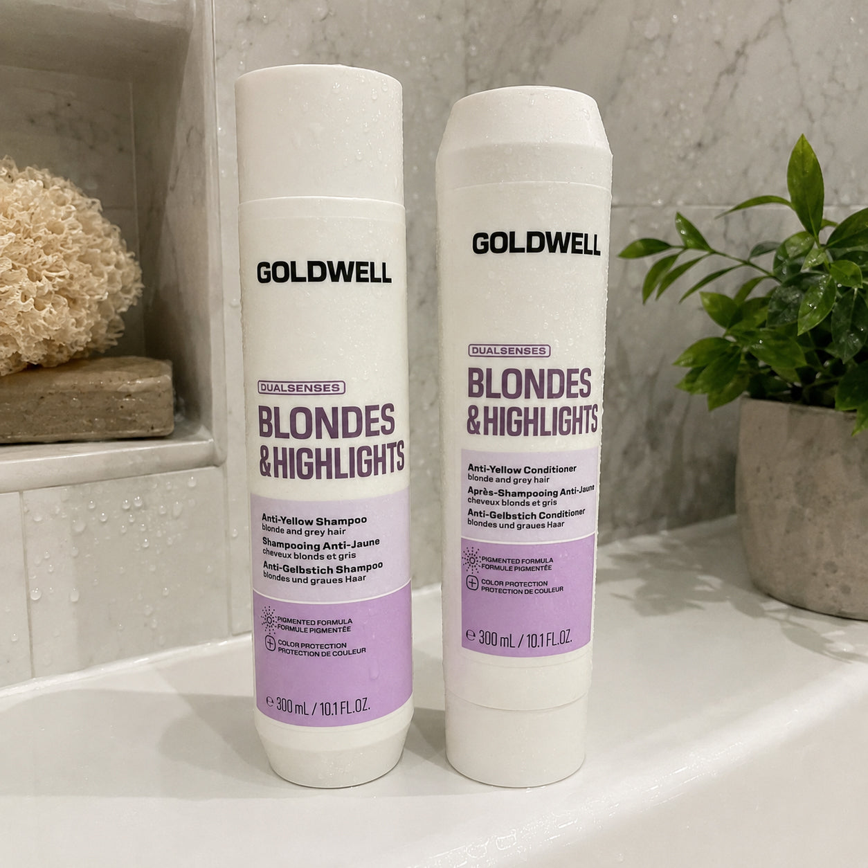 Goldwell Dualsenses Blondes and Highlights shampoo and conditioner displayed in shower for blonde hair care