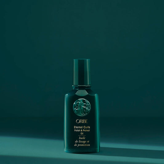 Oribe Eternal Curls Polish & Protect Oil bottle on a teal background