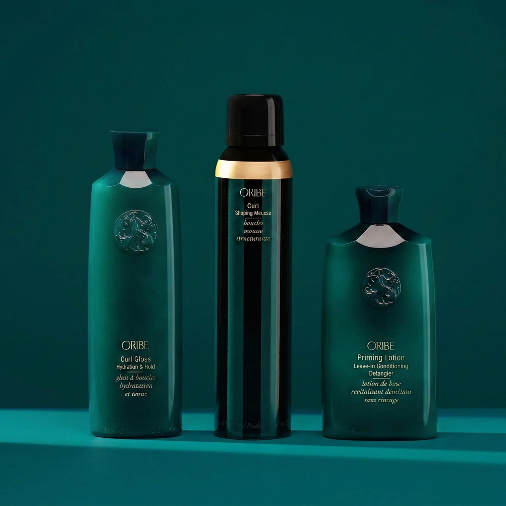 Oribe curl care set including Curl Gloss, Curl Shaping Mousse, and Priming Lotion Leave-In for defined, frizz-free curls