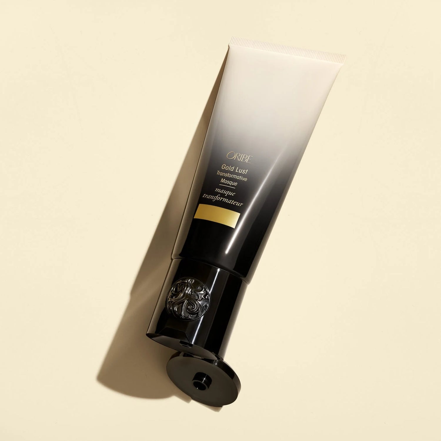 Oribe Gold Lust Transformative Masque tube showcasing rich conditioning formula