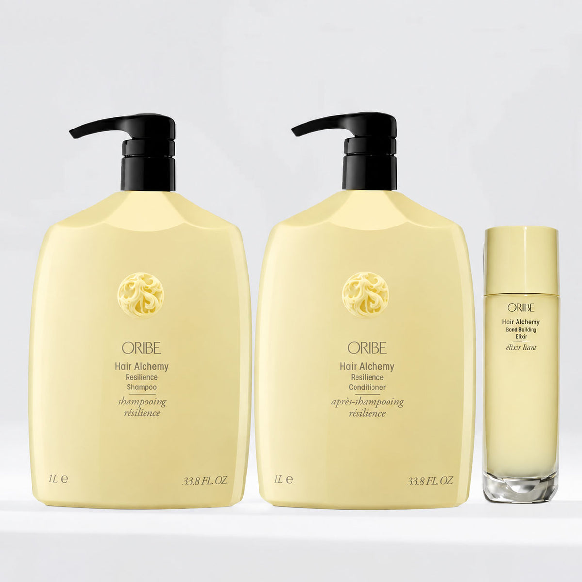 Oribe Hair Alchemy Resilience Shampoo and Conditioner 1-liter bottles with Bond Building Elixir, a strengthening hair care set for fragile, breakage-prone hair.