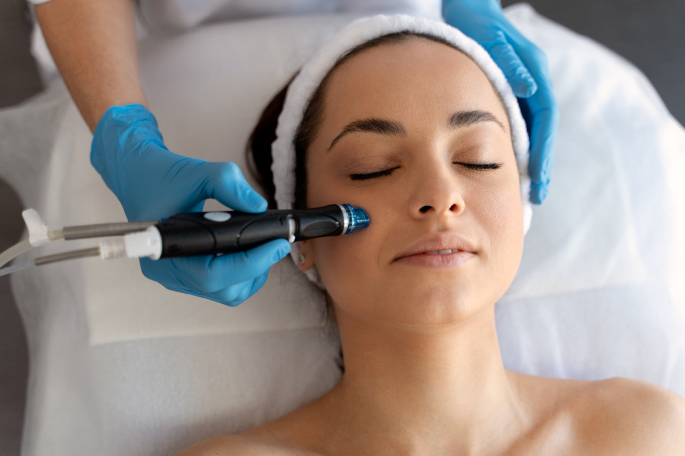 Woman relaxed in the middle of a hydrafacial service at Dolce Lusso Salon and Spa