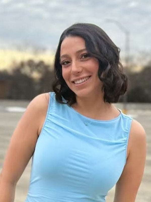 Kimmie Danjou Stylists at Dolce Lusso Myrtle Beach outdoors in a blue top