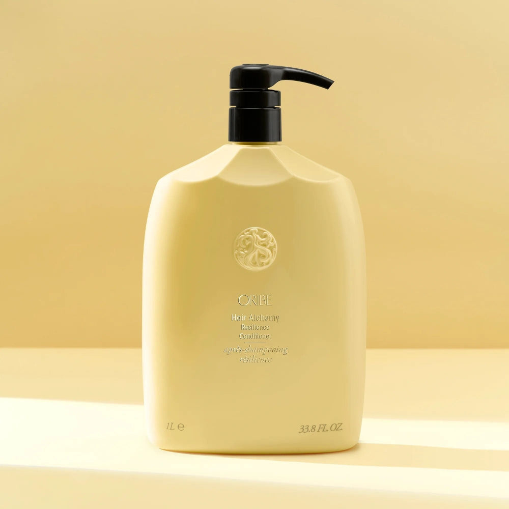 Liter size Oribe Hair Alchemy conditioner bottle for hydration and breakage prevention