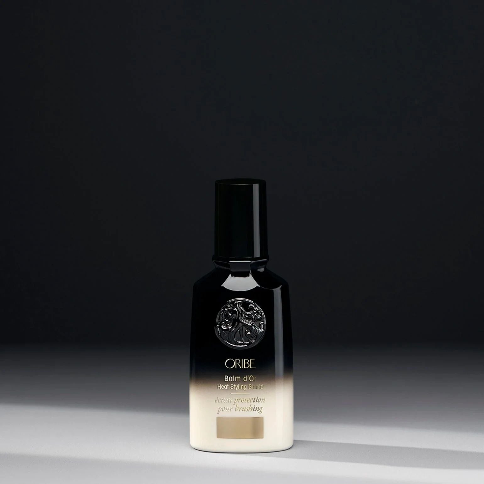 Oribe Balm d’Or Heat Styling Shield lightweight heat protectant for smooth frizz free hair
