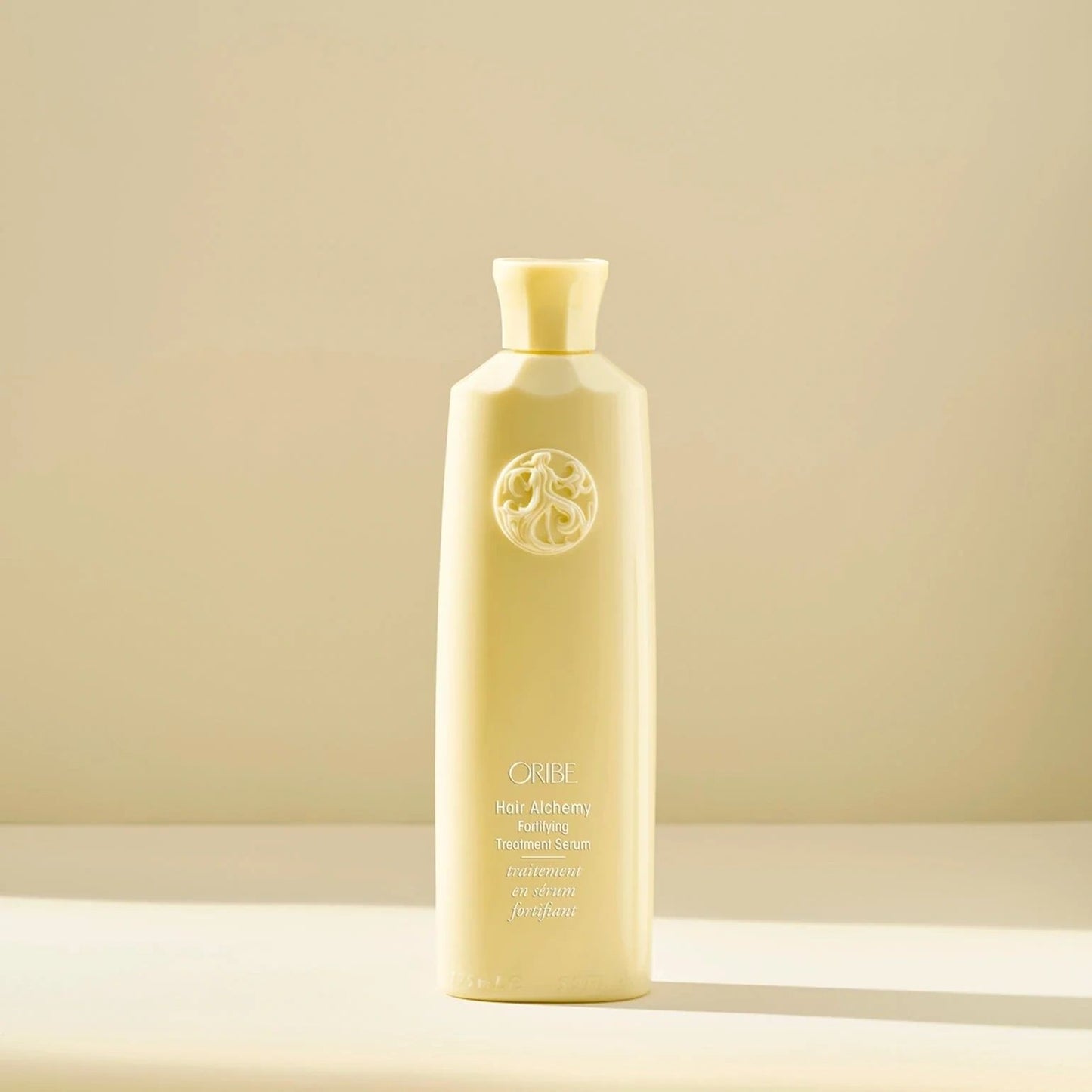 Oribe Hair Alchemy Fortifying Treatment Serum bottle for strengthening fragile hair and preventing breakage