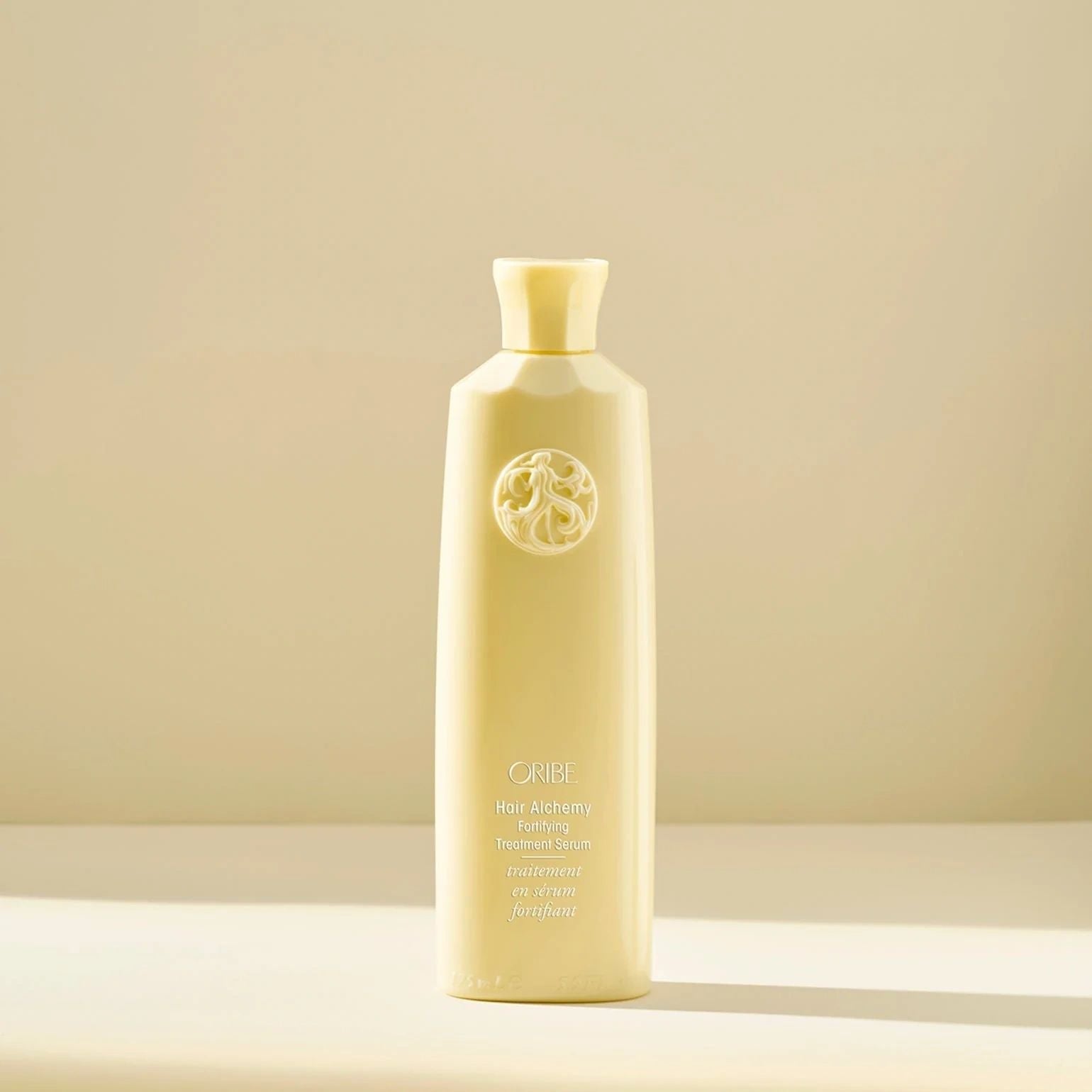 Oribe Hair Alchemy Fortifying Treatment Serum bottle for strengthening fragile hair and preventing breakage