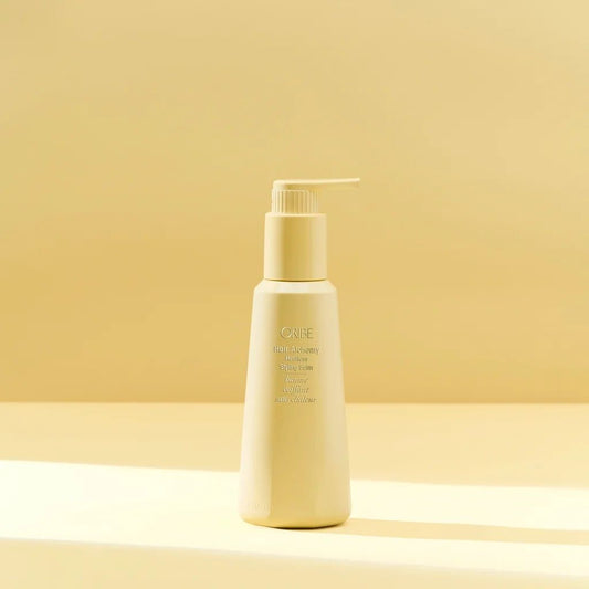 Oribe Hair Alchemy Heatless Styling Balm bottle for air-dry styling and enhancing natural hair texture