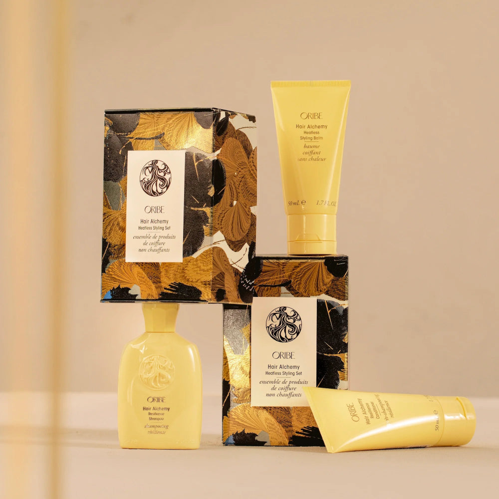 Oribe Hair Alchemy gift set packaging with travel size hair care products for strengthening and repair