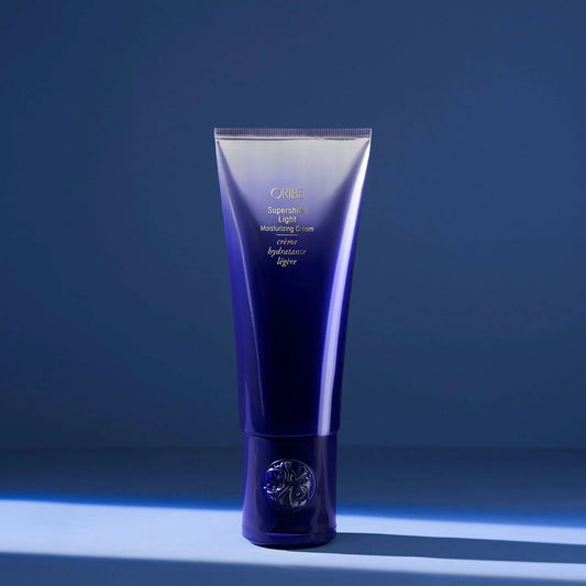 Oribe Supershine Light Moisturizing Cream in blue tube for lightweight hydration, shine, and frizz control
