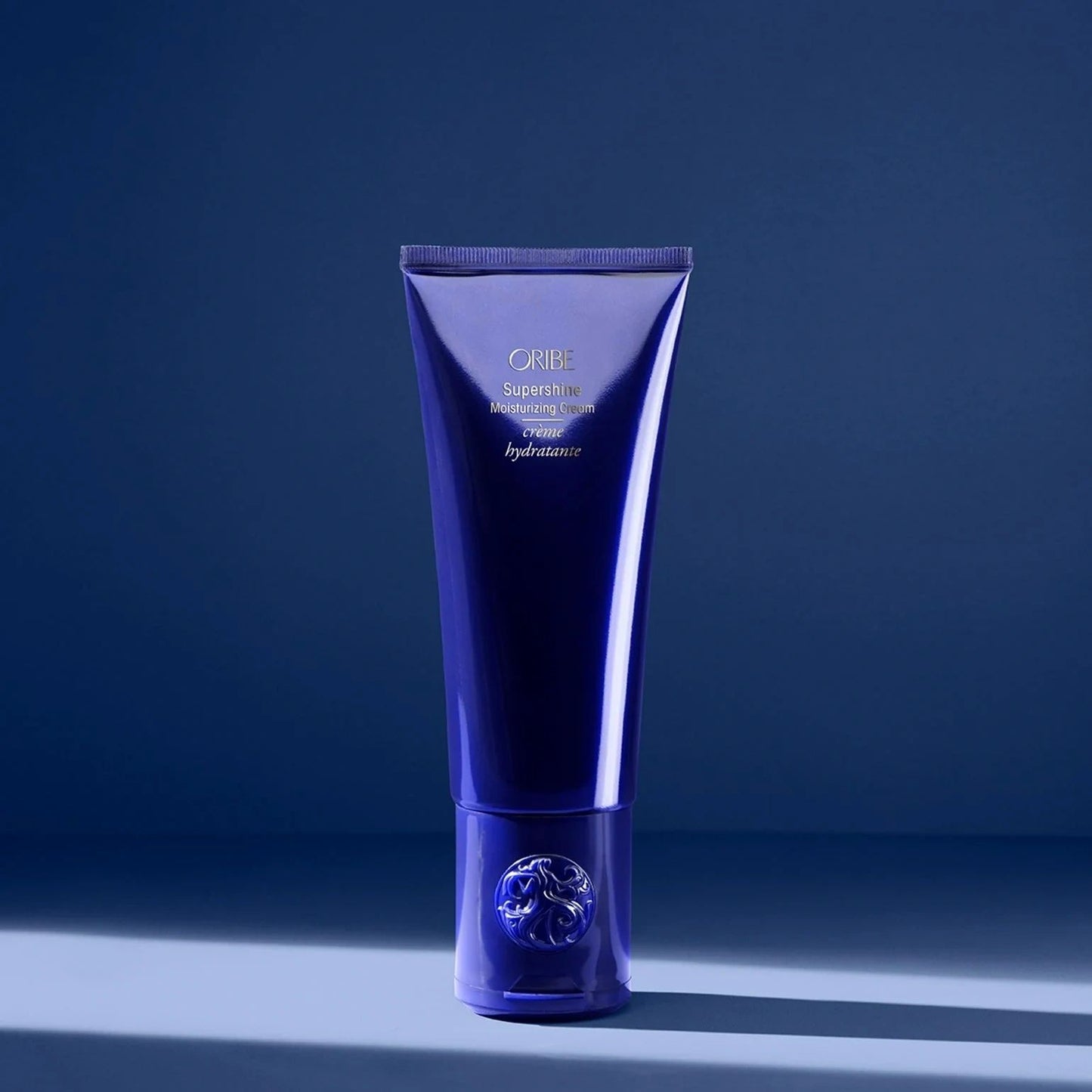 Oribe Supershine Moisturizing Cream in blue tube for deep hydration, shine, and frizz control