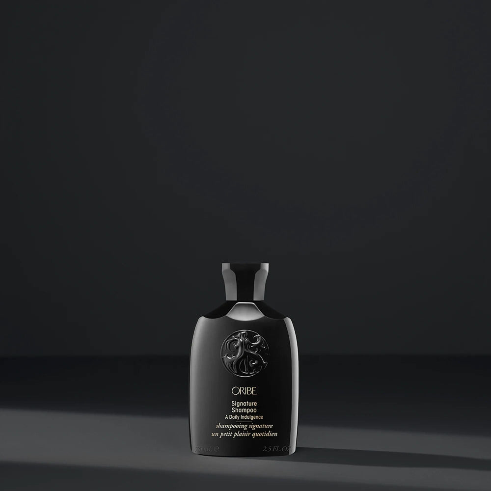 Oribe Travel Size Signature Shampoo sleek black bottle for everyday hair cleansing and nourishment