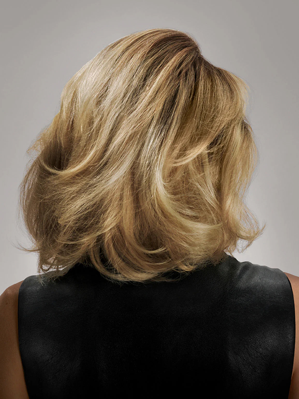 Thick, voluminous hair styled with Oribe volumizing and densifying products
