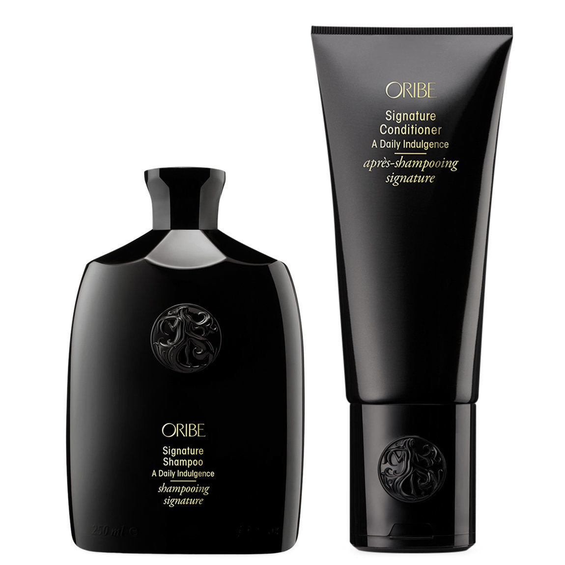 Oribe signature shampoo and conditioner bottles on a white background