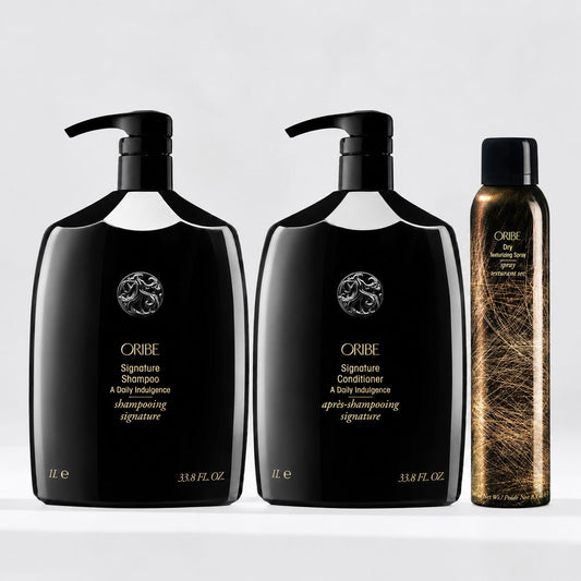 Oribe Signature Shampoo and Conditioner 1-liter bottles with Dry Texturizing Spray, a luxury hair care set for cleansing, conditioning, volume, and texture.