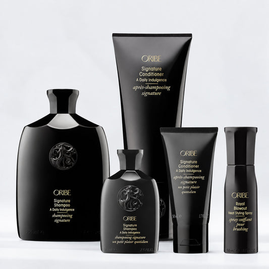 Oribe Signature Shampoo and Conditioner with travel-size shampoo, conditioner, and Royal Blowout Heat Styling Spray, a luxury hair care set for cleansing, hydration, and styling.