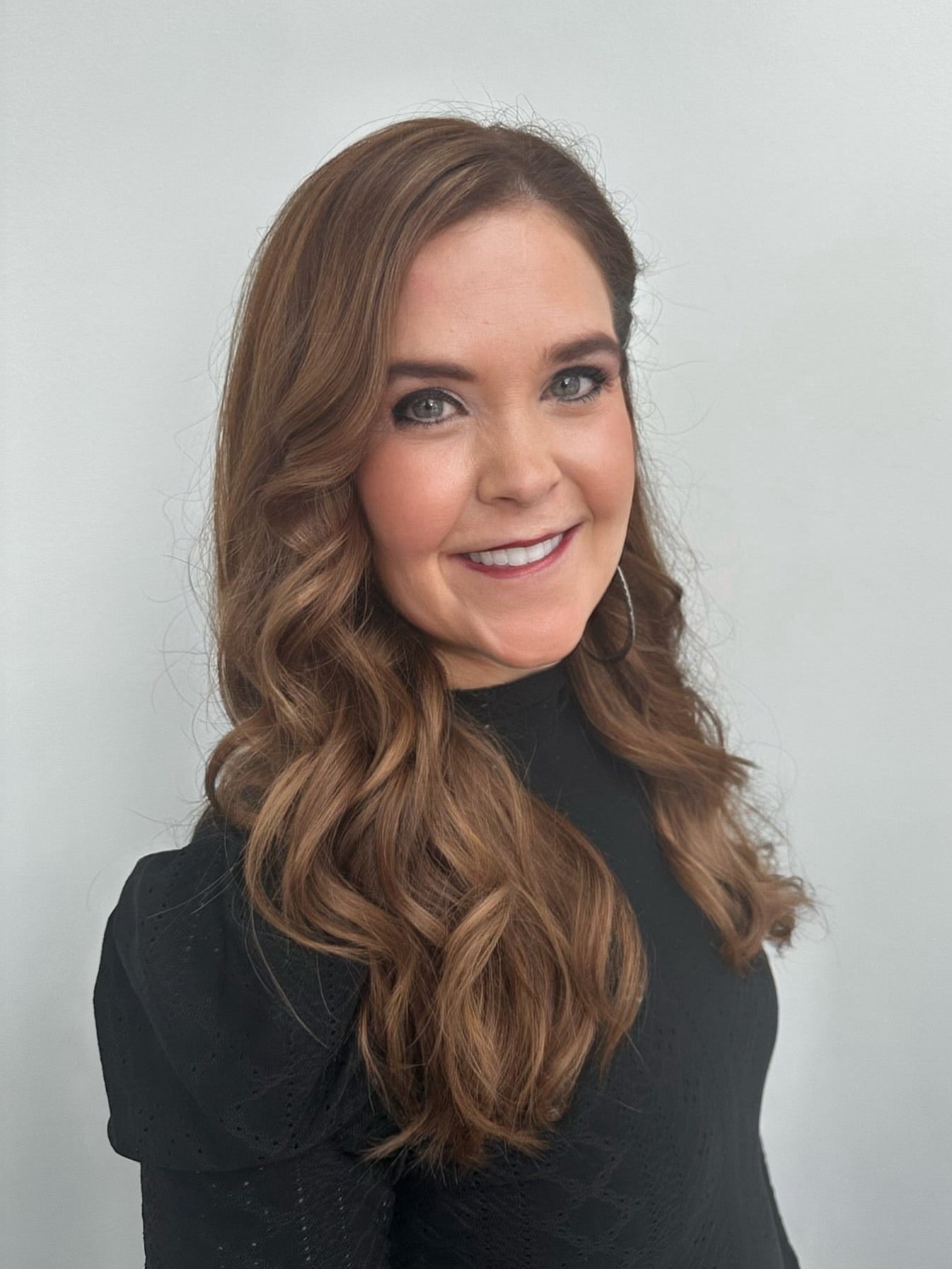 Image of Dolce Lusso Stylist Suzanne Raynor in a black shirt on a white background