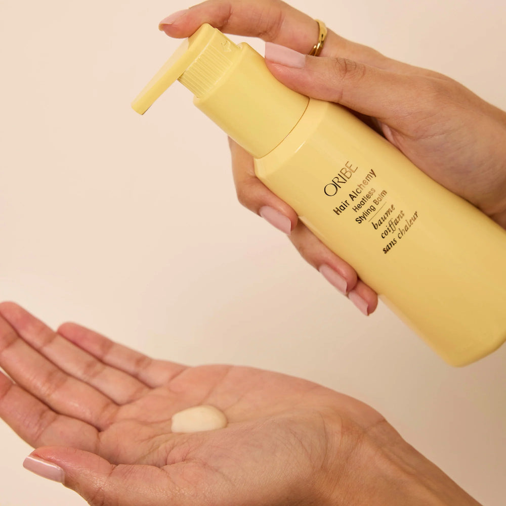 applying heatless styling balm into hands before styling for smooth distribution
