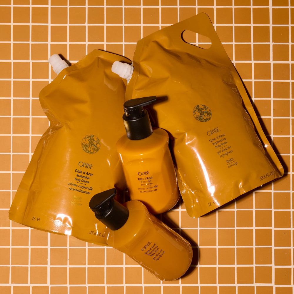 Côte d’Azur body care products including body wash and body cream arranged on patterned background