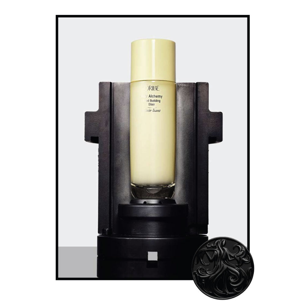 Oribe Hair Alchemy Bond Building Elixir displayed in testing apparatus highlighting advanced bond-building technology