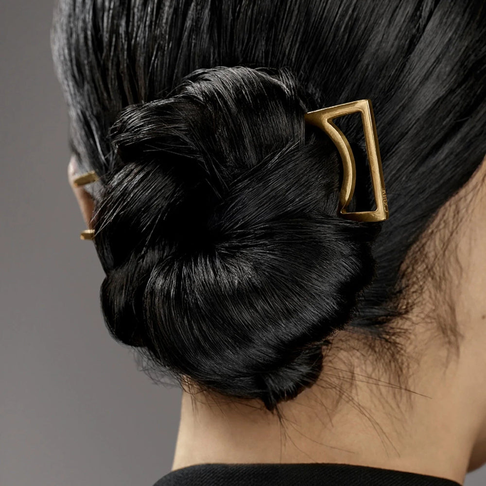 Elegant updo hairstyle finished with Oribe Superfine hairspray for flexible hold and shine