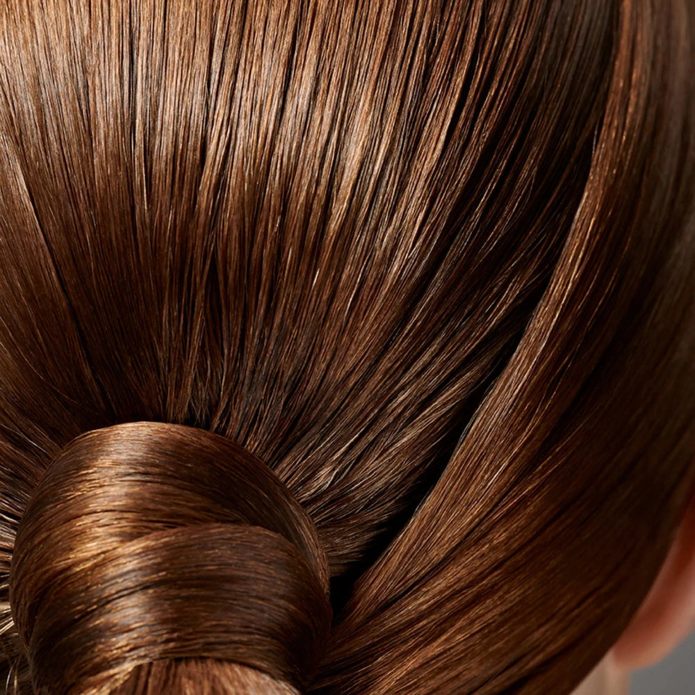 Smooth shiny hair finish using Oribe Superfine Strong hairspray for lasting hold