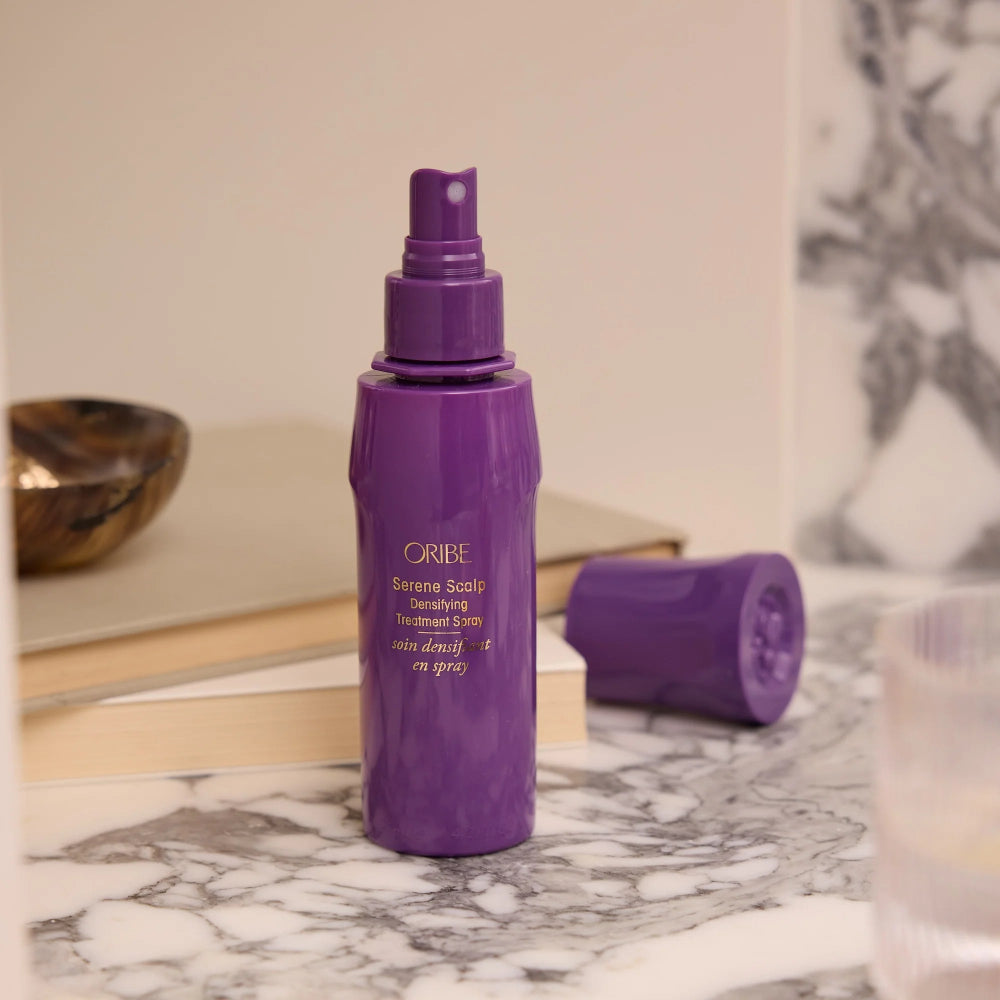 Oribe Serene Scalp densifying treatment spray styled on countertop for daily thinning hair routine