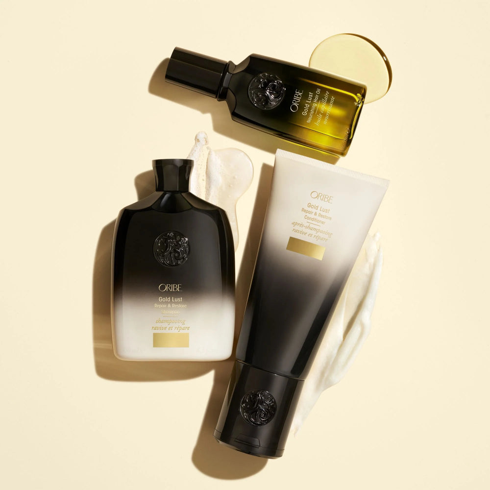 Oribe Gold Lust shampoo conditioner and nourishing hair oil luxury haircare flat lay