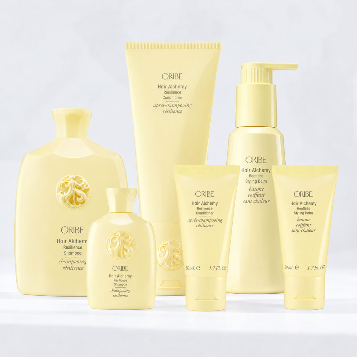 Oribe Hair Alchemy Resilience Shampoo, Conditioner, Fortifying Treatment Serum, and Heatless Styling Balm in signature yellow packaging, a strengthening hair care collection for fragile, breakage-prone hair.