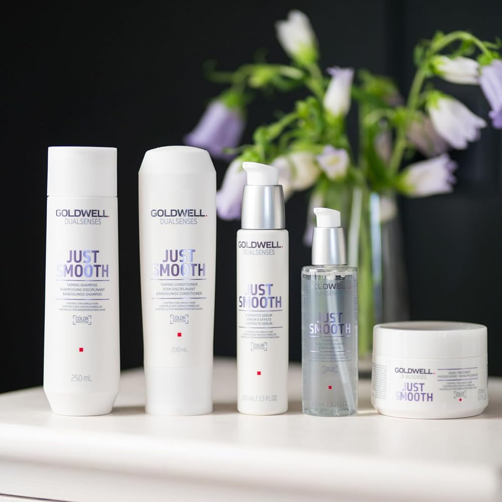 Goldwell Dualsenses Just Smooth hair care collection displayed on a vanity for sleek manageable hair