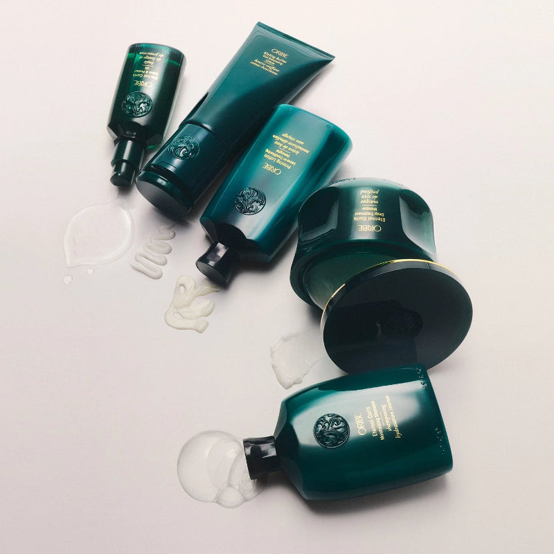 Product from the Oribe Eternal Curls collection sold at Dolce Lusso Salon laid out on a white background.