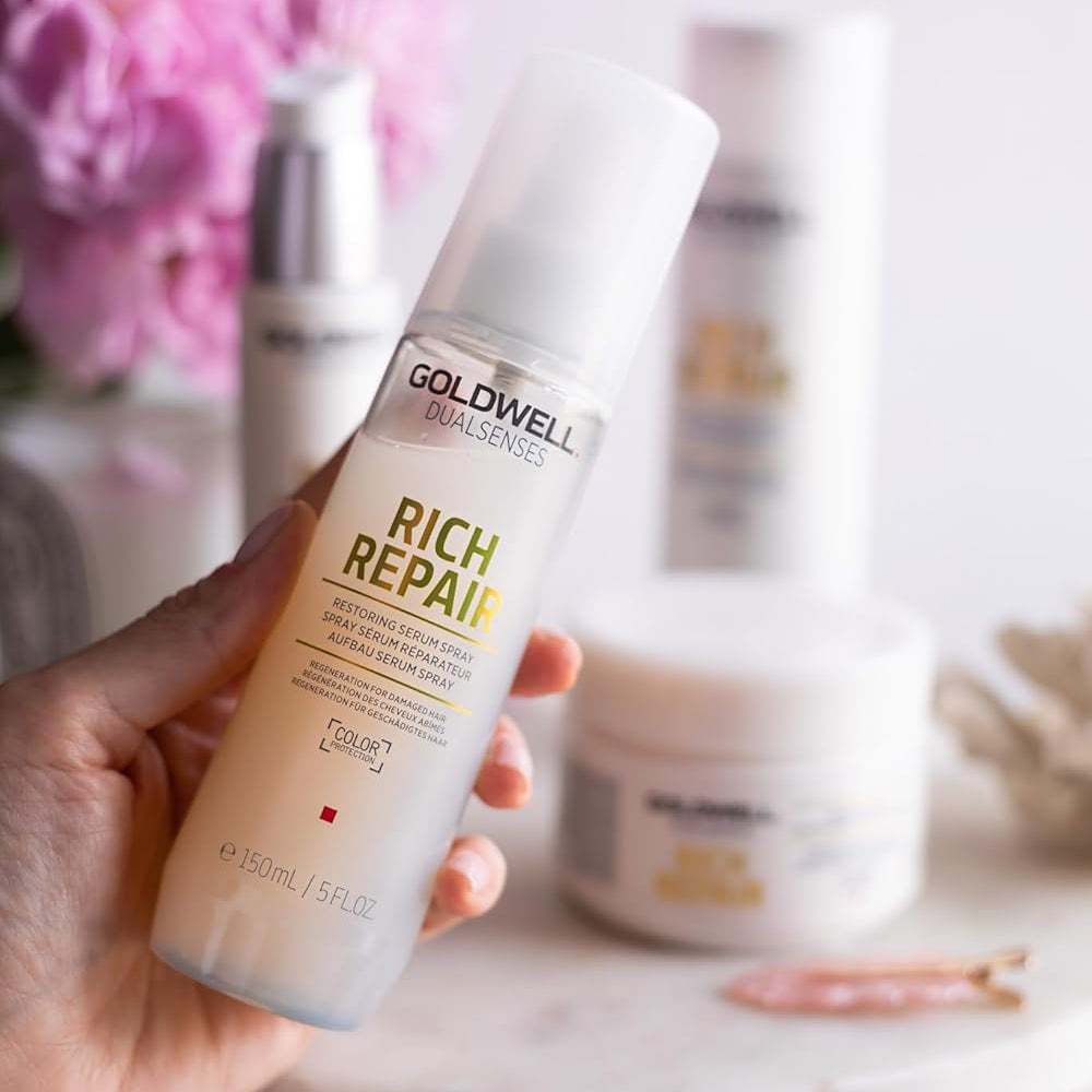 hand holding Goldwell Rich Repair serum spray for lightweight leave-in hair repair and smoothing
