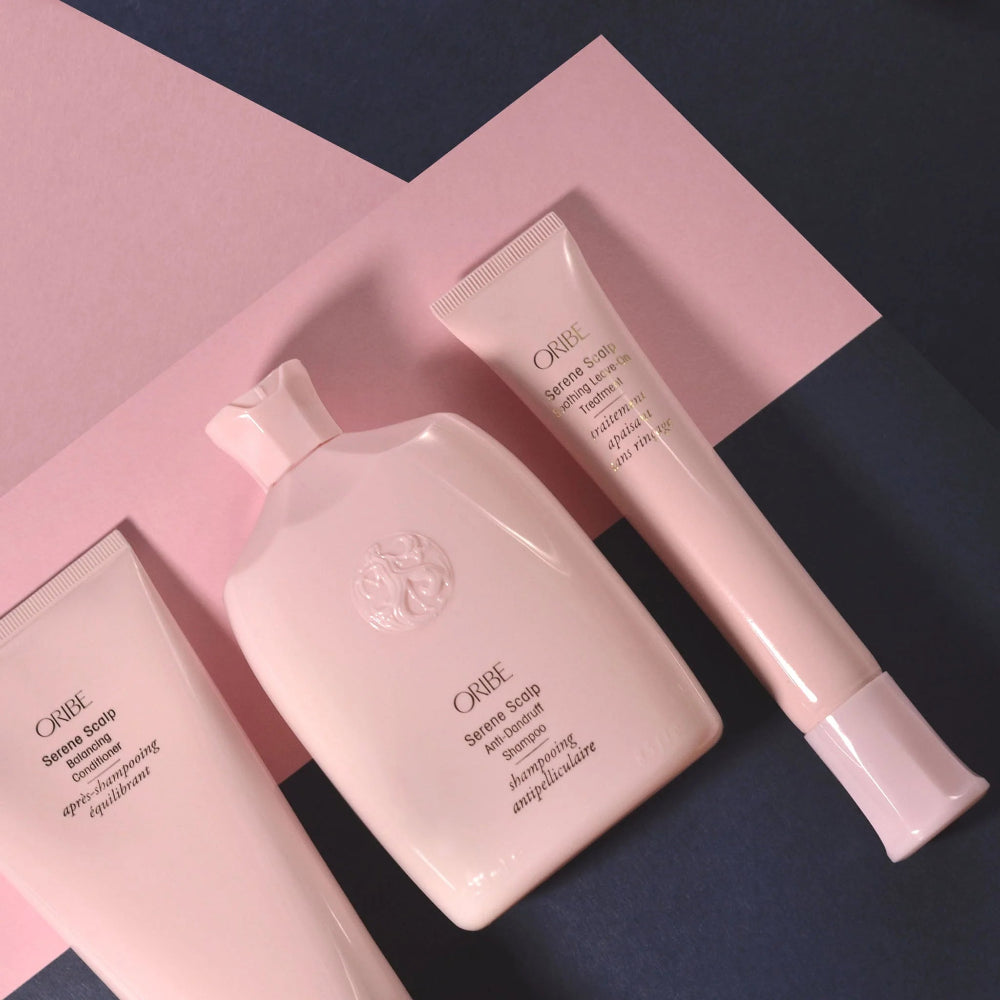 Three Oribe Serene Scalp collection products on a pink and blue/grey background