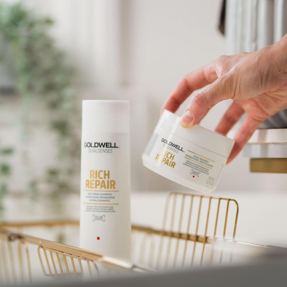 hand placing Goldwell Rich Repair shampoo in shower for daily hair repair routine
