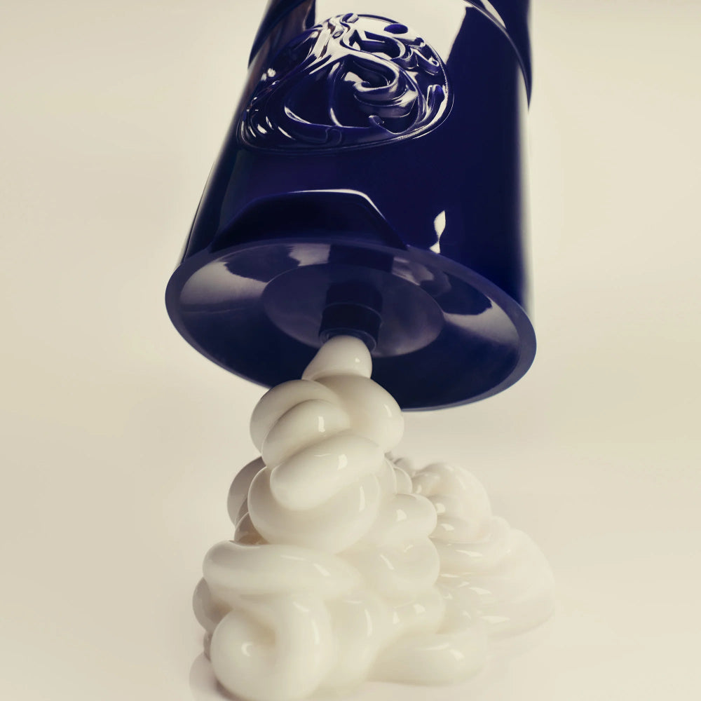 Oribe Supershine cream being dispensed showing rich, creamy texture for smoothing and moisture