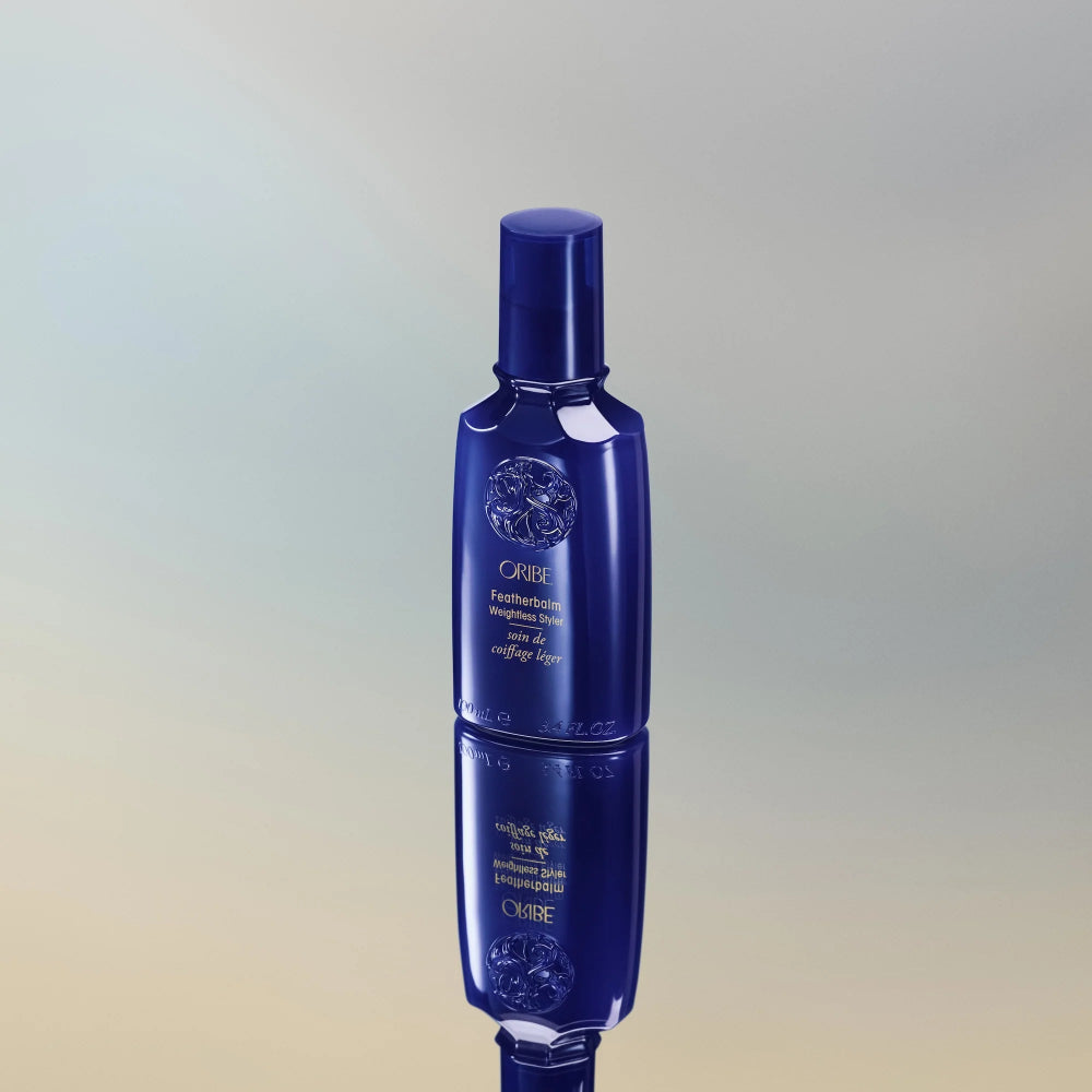 Oribe Featherbalm Weightless Styler bottle for soft hold, hydration, and frizz control