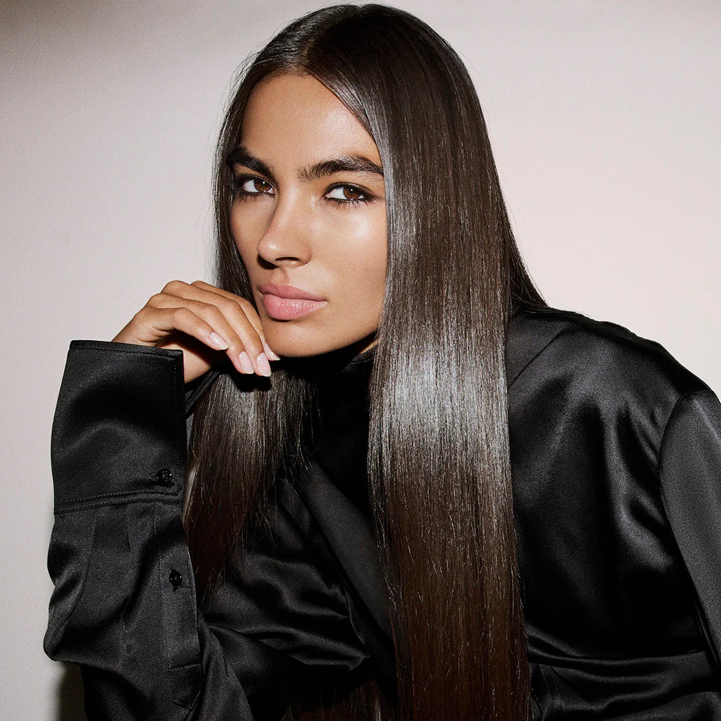 sleek, straight brunette hair with natural shine using Oribe Supershine Light Moisturizing Cream